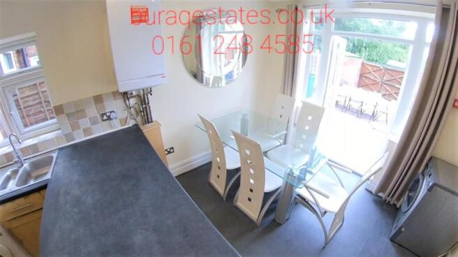 Bright, modern kitchen with a long breakfast ba...