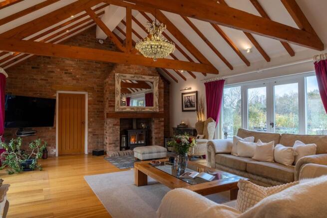 Vaulted ceilings and dual aspect patio doors onto the courtyard and garden