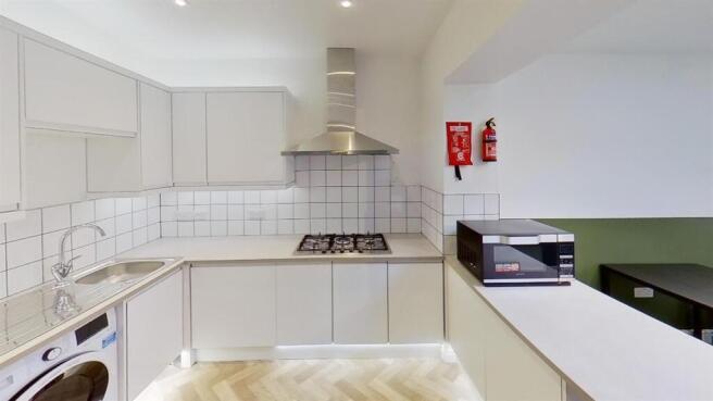 Modern kitchen with sleek white cabinetry...