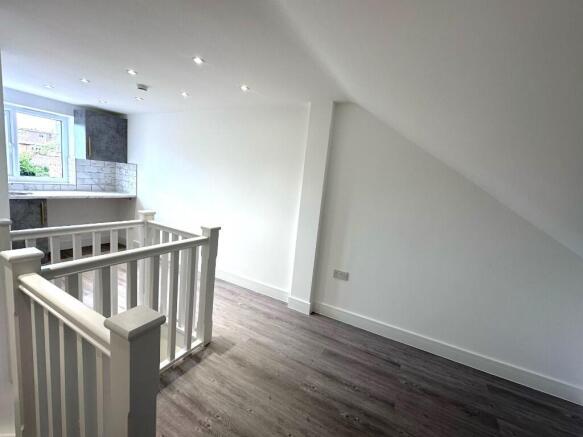 Bright first-floor landing with modern wood-eff...