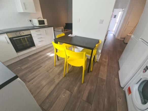 Bright and modern kitchen featuring white cabin...