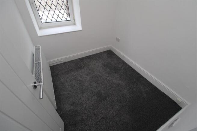 Freshly carpeted storage space with natural lig...