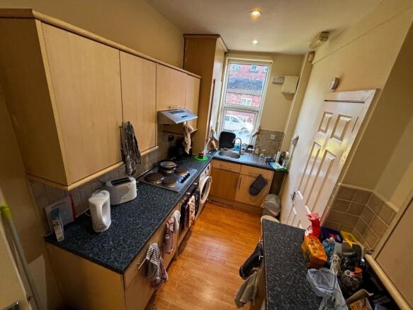Bright galley kitchen with wood-effect cabinets...
