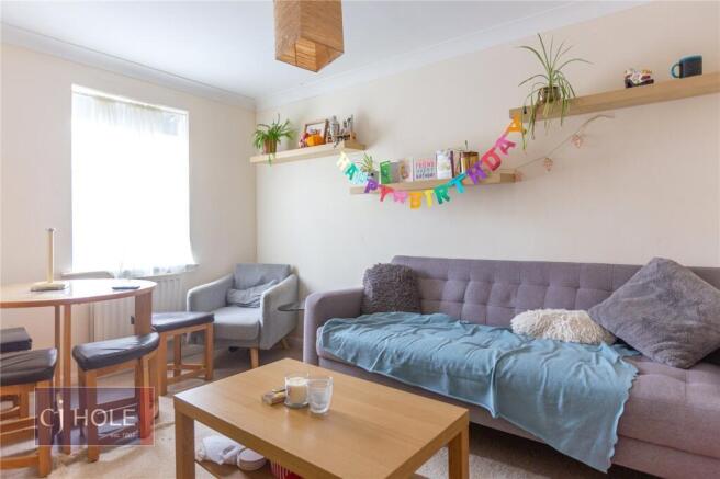 Bright and cozy living room featuring a comfort...