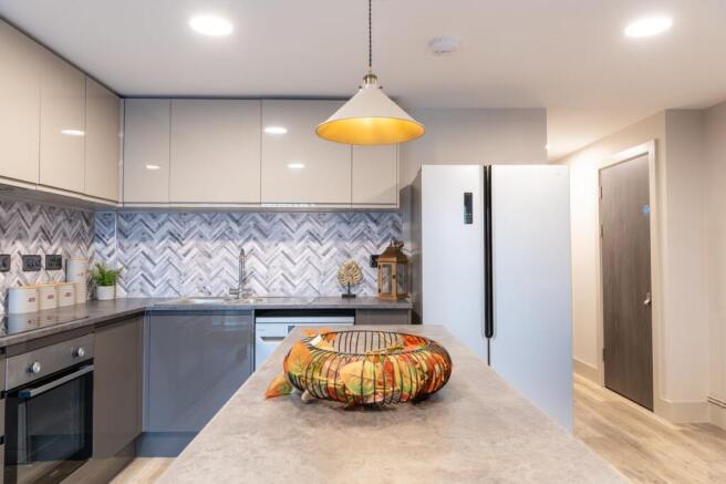 Modern fitted kitchen with sleek cabinetry, pat...