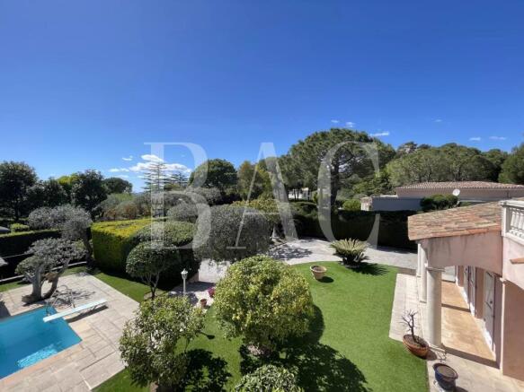 A luxurious villa with a swimming pool is surround