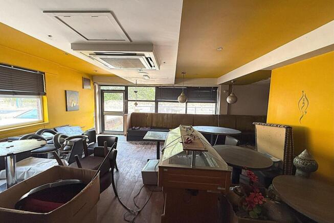 Bright communal lounge with seating and windows...