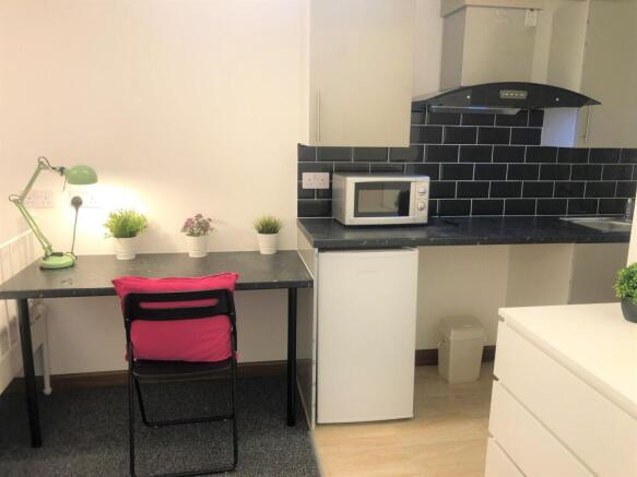Bright and tidy compact kitchen area featuring ...