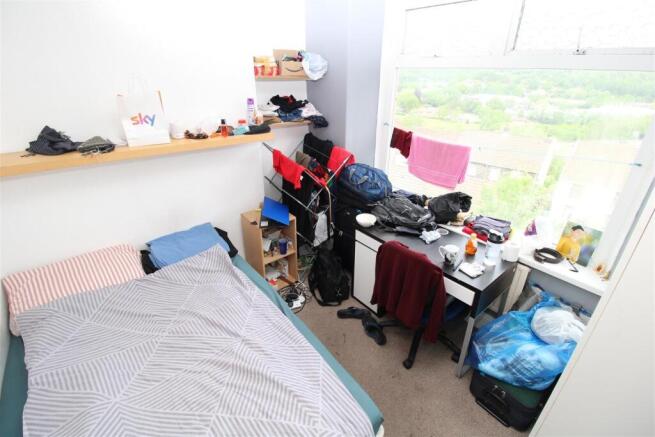 Bright bedroom with scenic views and large wind...
