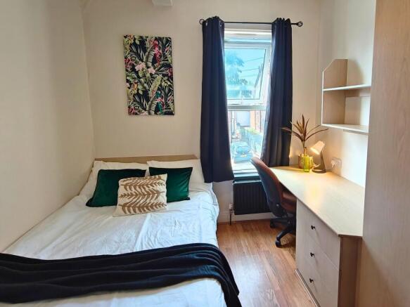 Bright, neatly presented bedroom with a double ...