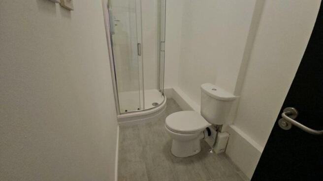 A clean and modern bathroom featuring a compact...