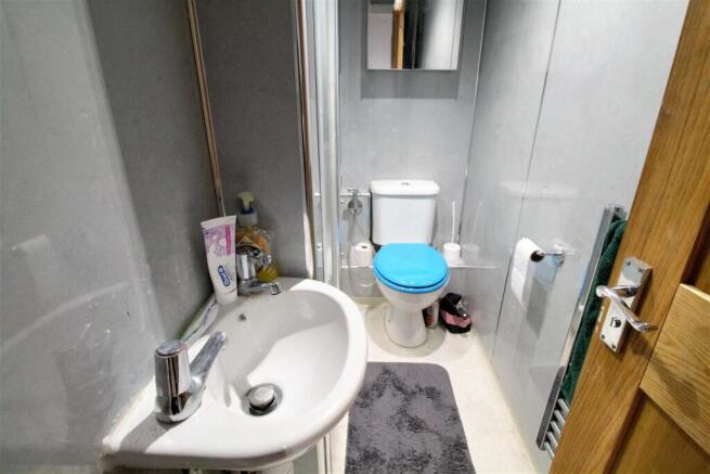 Clean modern bathroom with white suite...