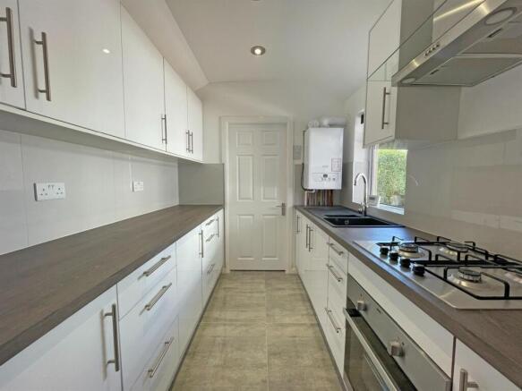 Modern white kitchen with ample counter space...