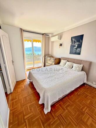 Bright and spacious bedroom with a view, featuring