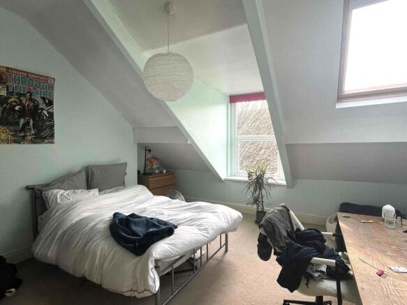 A bright and inviting master bedroom featuring ...
