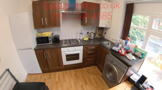 Bright fitted kitchen with wood-style cabinets,...