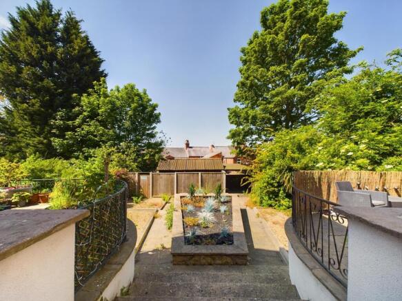 Well-maintained private garden with a central p...