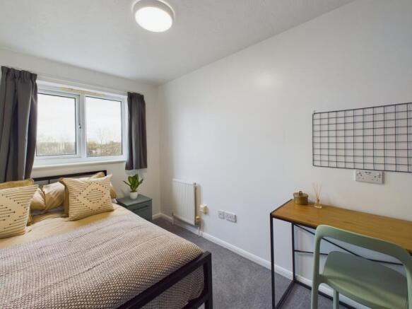 A bright and inviting double bedroom featuring ...
