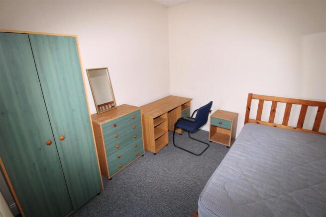 Bright bedroom with ample storage and study des...