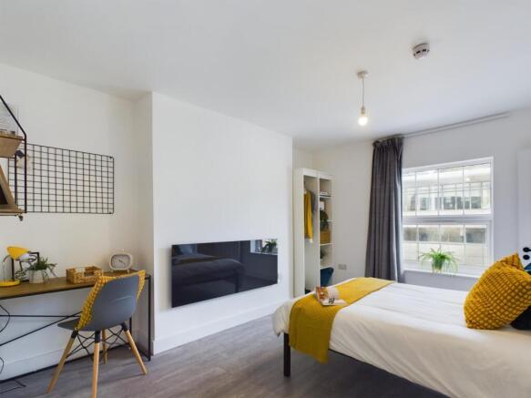 A bright and inviting double bedroom with moder...