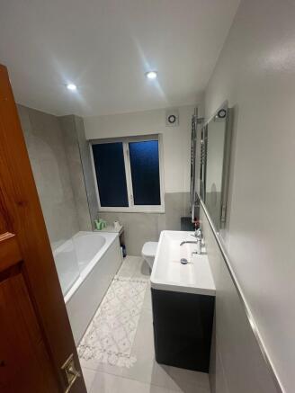 Modern bathroom with large bathtub and vanity...