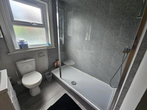 Modern bathroom with white suite, combined bath...