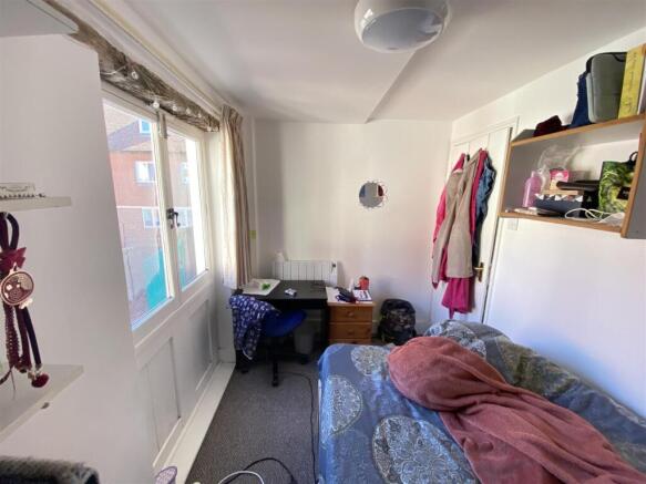 Bright bedroom with desk and natural light...