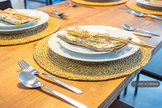 Dining Table Equipped With Complete Cutlery Set.