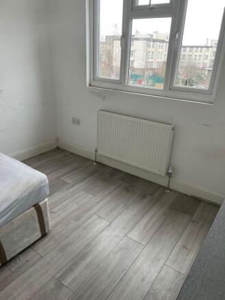 Bright bedroom with stylish wood-effect floorin...