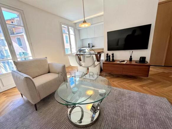 A modern living room with a glass coffee table, a