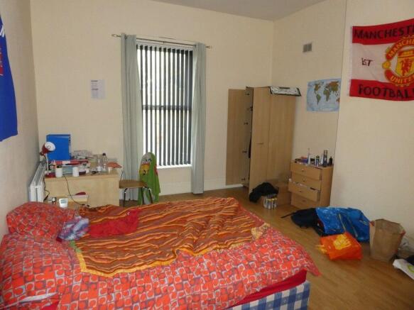 Cozy furnished bedroom with a single bed, wardr...