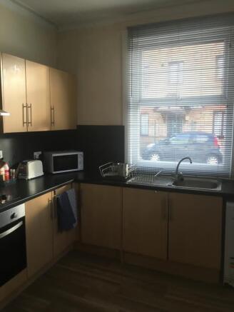 Bright, modern kitchen with light wood cabinets...