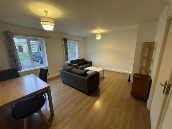 Bright and spacious living room with large wind...