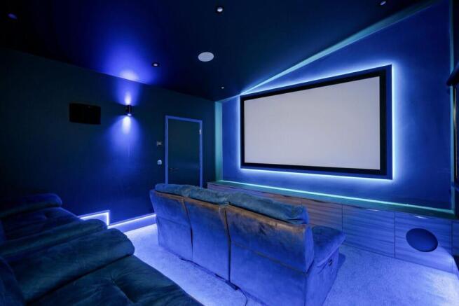 Private cinema with plush tiered seating and ambie