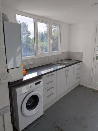 Bright laundry room with modern appliances....