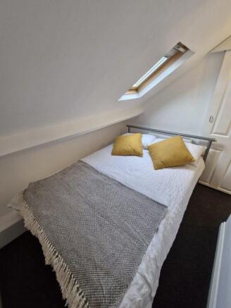 Bright attic bedroom with a cozy double bed...