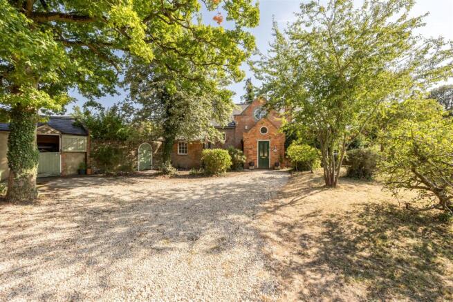 Set back behind ample driveway