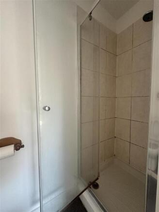 Bright bathroom with a sleek glass shower unit...