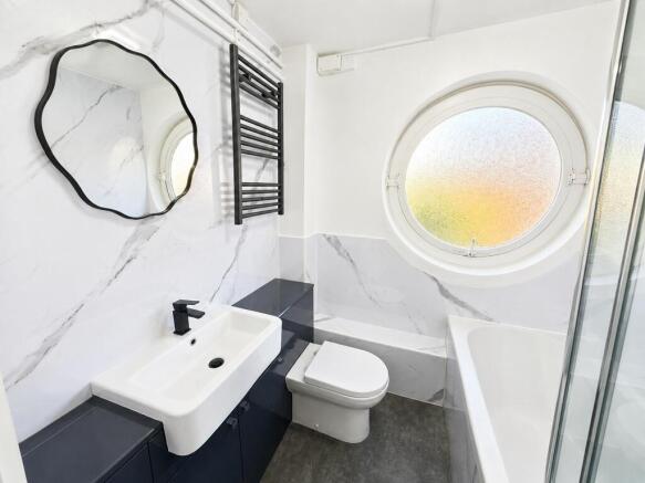 Sleek modern bathroom with marble-effect tiling...