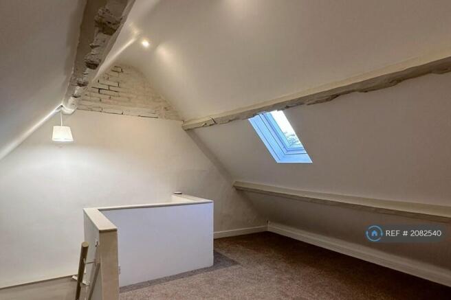 Spacious Carpeted Attic Room With a Vellux Window.