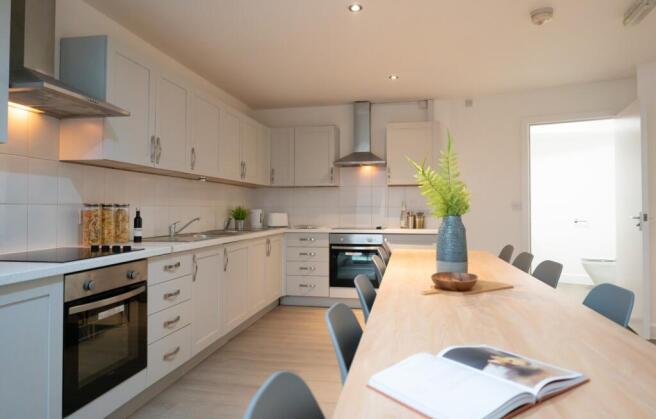 Modern kitchen featuring sleek cabinetry, ample...