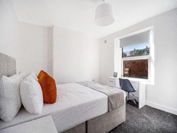 Bright, neatly presented bedroom with a comfort...
