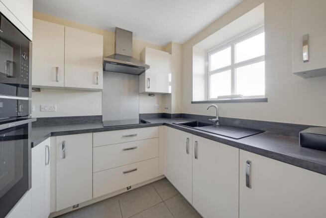 a kitchen with white cabinets