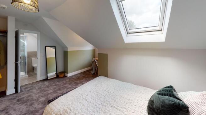 A cozy bedroom with a skylight providing abunda...