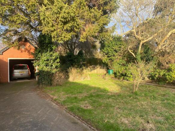 One of two garages with garden area surrounding