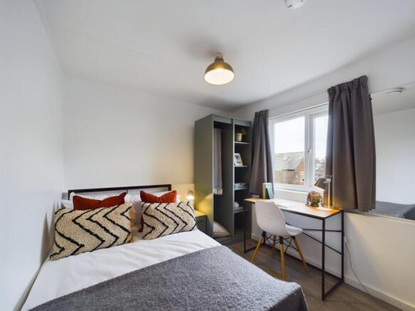 Bright, neatly presented bedroom with a comfort...