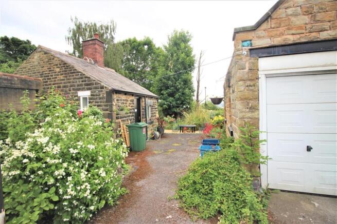 Charming stone outbuilding and lush garden spac...