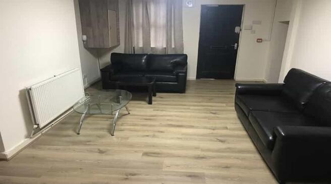 A spacious, well-maintained living room featuri...