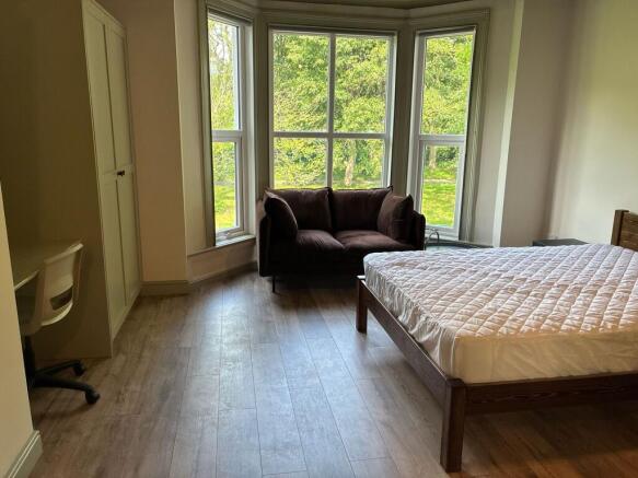 Bright master bedroom with large bay windows...