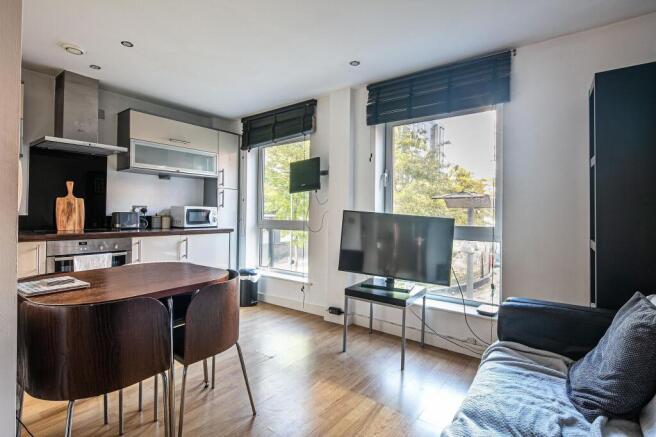 Bright open-plan living area with modern kitche...